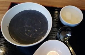 Serving of vegan Black Sesame Porridge (Heukimjajuk 흑임자죽) along with vegan radish Kimchi (Dongchimi 동치미) at Jukmiso - 죽미소 in Seoul