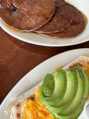 (A cramped photo of) Blueberry stuffed pancakes and breakfast burrito at Lotus Cafe and Juice Bar in Encinitas