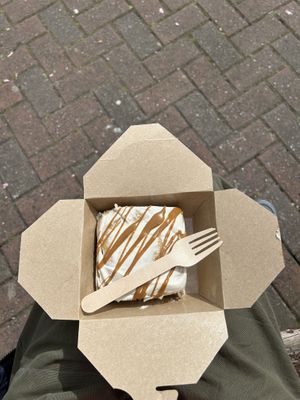 Cinnamon roll in cashew cream in a paper takeaway box   at It's a Trap in Dublin