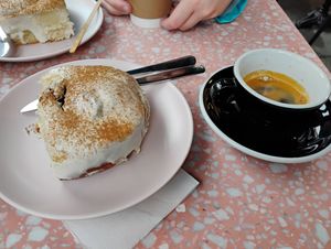 A cinnamon roll pillow with cream cheese frosting and an espresso at It's a Trap in Dublin