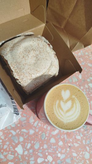 Cream cheese cinnamon roll and latte at It's a Trap in Dublin