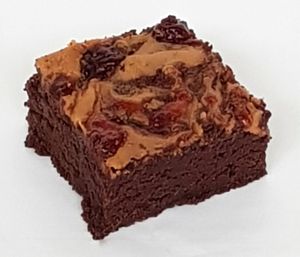 Our Peanut Butter and Jam Brownie, filled with dairy-free chocolate and topped with peanut butter and strawberry jam at The Naked Vegan in Cardiff