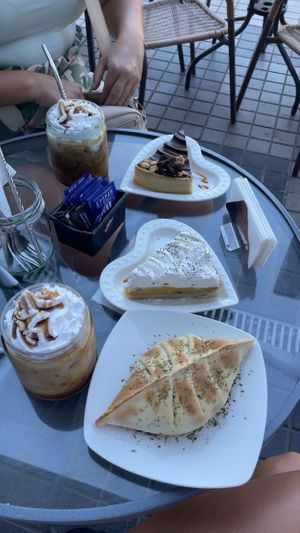 Tomato, Basil, Corn and Cheese Empanada, Almond Milk Caramel Frappe, Snickers Cake and Passionfruit Meringue Cake 🍰   at La Converseria in Santiago