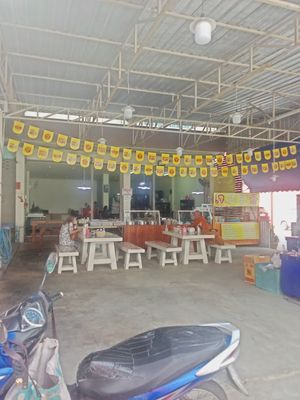 The inside , a monk visiting, too. Eating dumplings. at J Ton-po in Bangkok