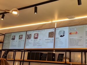 Menu on screens above counter at Otto Waffle Atelier in Bruges