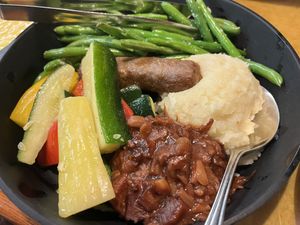 Vegan skillet with veggies, mashed potatoes, bbq jackfruit, and an impossible sausage   at Garden Grill in Orlando
