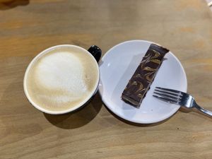 Oat Latte and Caramel and Chocolate cheesecake!   at The Quirk Space in Olney