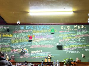 The fat dog menu is on the wall behind the counter ✌️ at Fat Dog in Rotorua