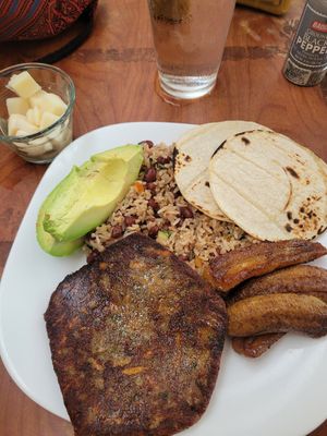 Gallo pinto with the patty and including the palmito (palm heart) in the separate glass bowl on the left at Restobar Balú in Quepos