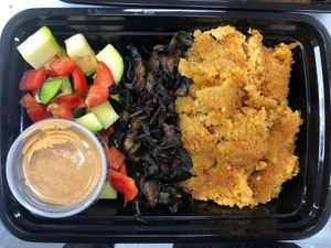 Breakfast bowl; crispy smoked maple Portobello, raw veggies and chickpea patty topped with chipotle mayo at Unveil Nutrition in Lodi