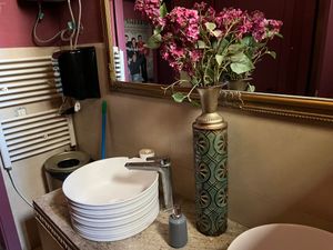 Floral arrangement by the bathroom sinks at Sonder in Pristina