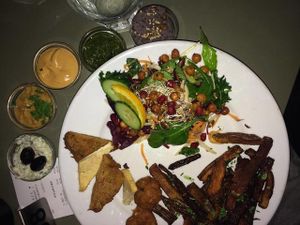 The "Veggedelletallerken" translated to english veggie "meatball" plate with root-fries, salad and five wonderful dips on the side. The pesto is especially good! at Cafe N in Copenhagen