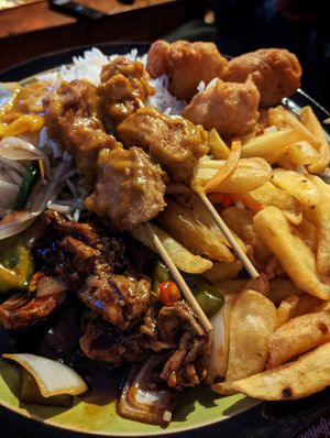 Satay skewers, chilli chips, vegan chicken balls and tofu in green pepper and black bean sauce at 9 Dragons in Folkestone