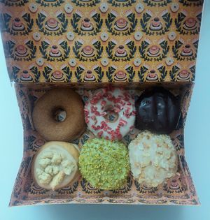 Bram's 6 Favourites: [clockwise] cinnamon sugar, white chocolate strawberry, Boston cream, bienenstich, pistachio, apple crumble at Brammibal's Donuts - KaDeWe in Berlin