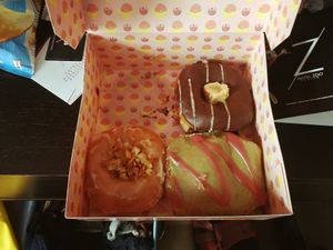 Crunchy coconut almond, chocolate with cream and apple donut at Brammibal's Donuts - KaDeWe in Berlin