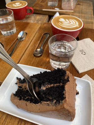 Delicious vegan chocolade cake and oat flat whites. at Vita Brevis in Sitges