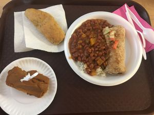 Burrito relleno de arroz con gandules, y majado de viandas. Arroz blanco con habichuelas rojas encima. Budding the calabaza y batata. Pan con ajo. at Natural Life Cafe in Moca
