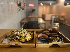 Nachos and birria tacos in the upstairs seating area   at Dalia Plant Power Mex in Bogota