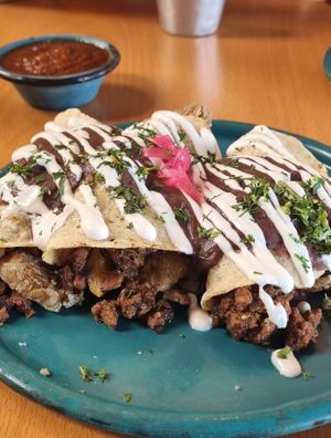 Enfrijoladas with chicharron + an extra of chicharron en salsa verde at Dalia Plant Power Mex in Bogota