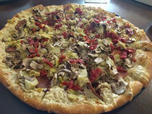 artichokes, sun dried tomatoes, mushrooms, pine nuts and Canadian ham with vegan garlic white sauce at Pizza Guru in Santa Barbara