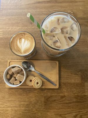 Flat white and iced chai latte - both with oat milk and teeny tiny jammie dodgers ❤️  at Mr Cooper's Coffee House in Whitby