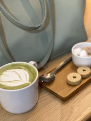 Matcha oat latte and jammy dodger biscuit  at Mr Cooper's Coffee House in Whitby