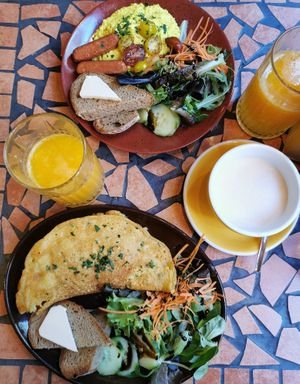 Kimchi omelette, scrambled tofu, fresh orange juice and chai latte at Palo Verde in Prague