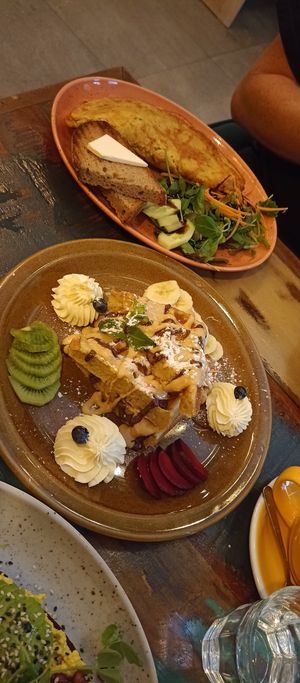 Omelet with kimchi and waffles with peanut sauce, chocolate sauce and whipped cream 🤤 at Palo Verde in Prague