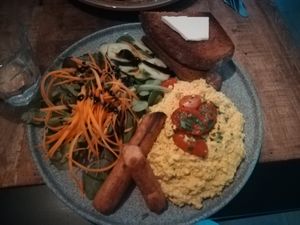Scrambled tofu and two sausages with salad and bread at Palo Verde in Prague
