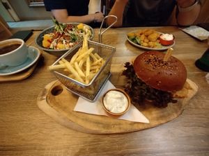 Korean no chicken burger, no chicken pops and seasonal palove bowl in the background  at Palo Verde in Prague