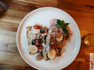 Waffles with cashew cream, maple syrup, fresh fruit and pink whipped cream at Palo Verde in Prague