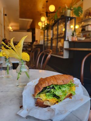 The most amazing vegan breakfast croissant that I've ever had!!! Just Egg, vegan bacon, creamy spread, greens, and a perfectly made croissant, a whole other level of incredible! at Terms of Endearment in Brooklyn