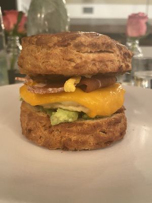 Breakfast sandwich. Biscuit, egg and cheese with avocado and added bacon at Terms of Endearment in Brooklyn