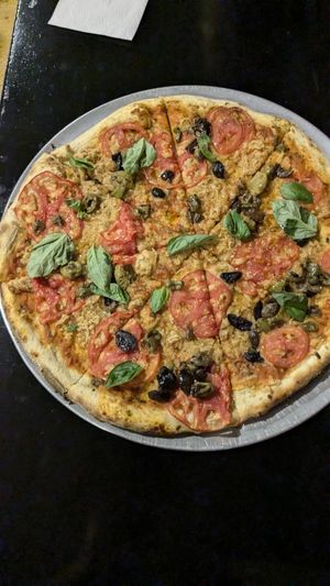 Large Pizza 🍕 (45cm for 80BOB) toppings are 10 BOB each. Vegan cheese as well. This one was 120BOB (vCheese, Tomato, Olives, Basil) at Minuteman Pizza in Uyuni