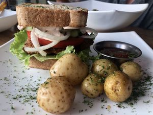 Chicken sandwich with roasted potatoes  at Karma in Jaco
