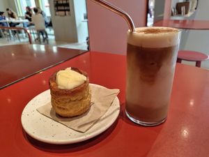 Iced coffee with hazelnut butter, and cinnamon roll at Buddy Buddy in Brussels