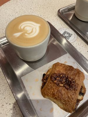 oat latte and pain au chocolat  at Buddy Buddy in Brussels