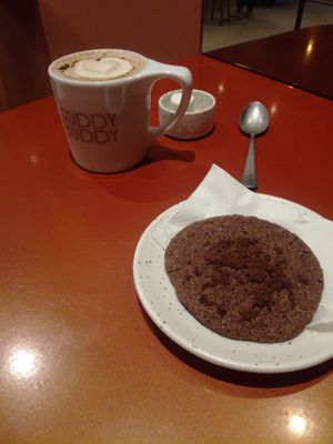 Hot chocolate (oatmilk) with double chocolate cookie at Buddy Buddy in Brussels