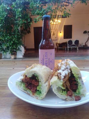 Baguette filled with chorizo (soy), caramelized onion, zuchinni, vegan alioli. at La Barra Cocina y Comunidad in Guadalajara