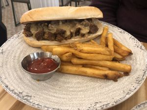 Philly cheesesteak sub with fries at Veggie Grill by Next Level - W 23rd in New York City