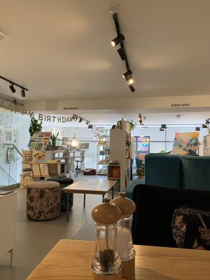 Indoor seating (two tables) upstairs in the thick of art at MerseyMade in Liverpool
