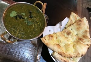 Lentil and spinach dish with garlic naan  at Bhaji Pala in Gatley