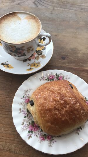 Oat milk cappuccino and vegan chocolatine at Epicerie Muscade in Montreal