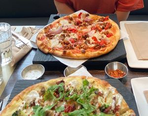 Sweet pepper & sausage pizza and pesto CBR pizza at Virtuous Pie in Victoria
