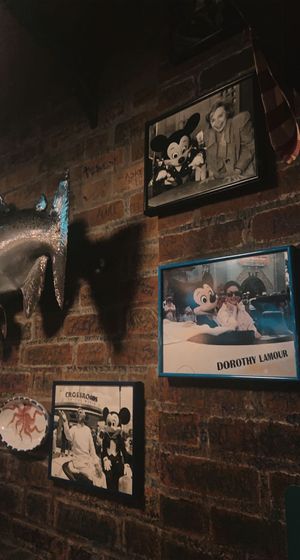 celebs w mickey can be found scattered on the wall  at Walt Disney World - Mama Melrose's Ristorante Italiano in Lake Buena Vista