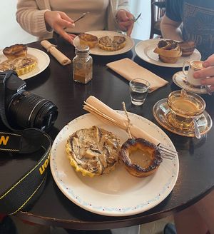 selection of mushroom tarts, pastel de natas and coffees!  at Odete Bakery in Porto