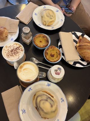 Cinnamon rolls, pastel de nata, coffees, croissants  at Odete Bakery in Porto