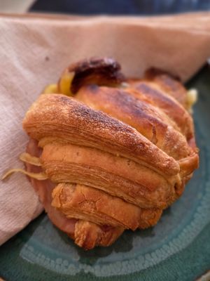 Warm croissant with cheese and ham at Odete Bakery in Porto