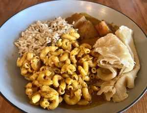 Pumpkin curry, Mac n cheese, roti, rice and peas  at Desmond's Island Soul Grill in Virginia Beach