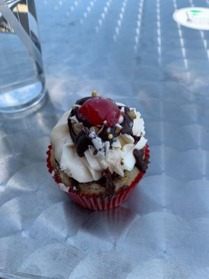 banana-split vegan cupcake! So good! Can I get a truckload of these? at Flourish Plant-Based Eatery in Evansville